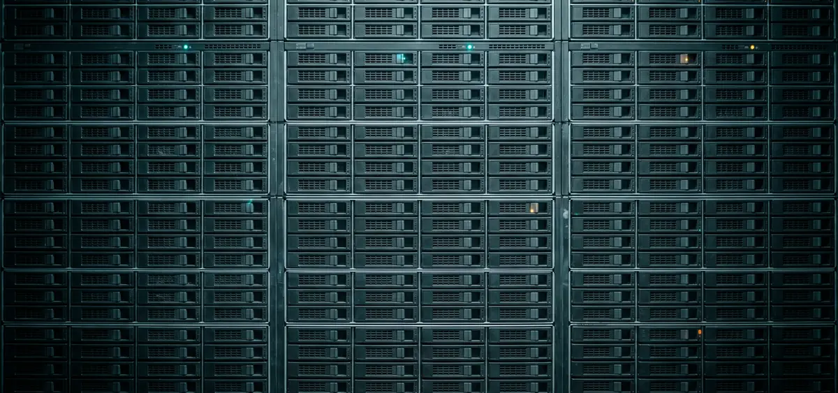 A wall of identical rack-mounted servers where only a handful show lit status indicators